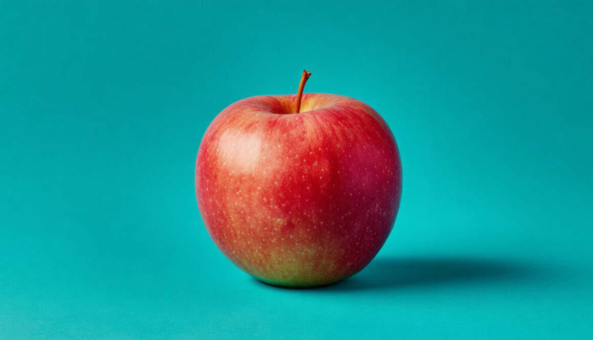 Whole red apple isolated on aqua green background, 16:9 aspect ratio – free stock photo for commercial use