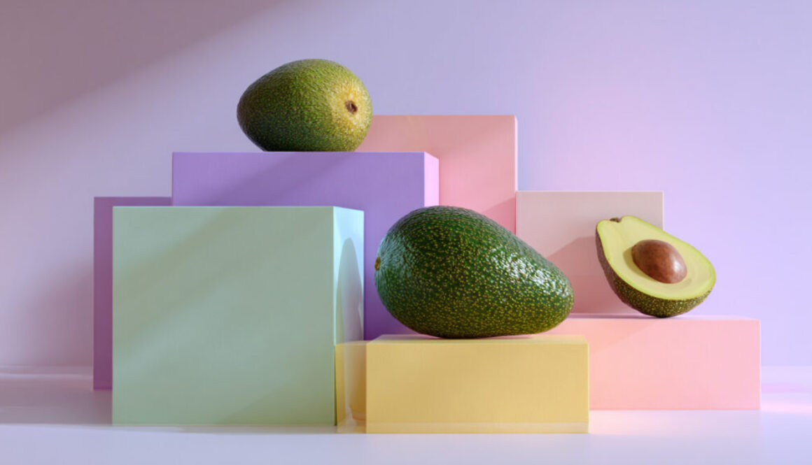 Geometric still life of avocados on pastel-colored blocks with lavender background in 16:9 format