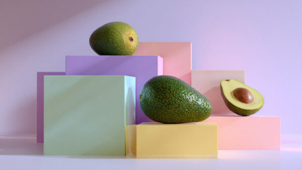 Geometric still life of avocados on pastel-colored blocks with lavender background in 16:9 format