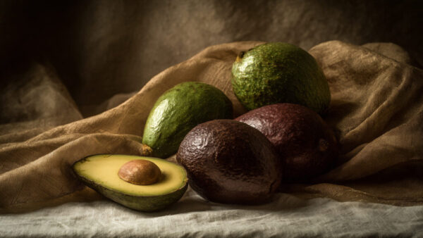 Still life composition of avocados on brown fabric background in 16:9 format