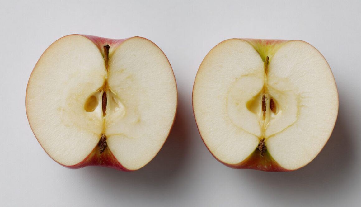 Sliced red apple on clean white background – minimalist stock photo