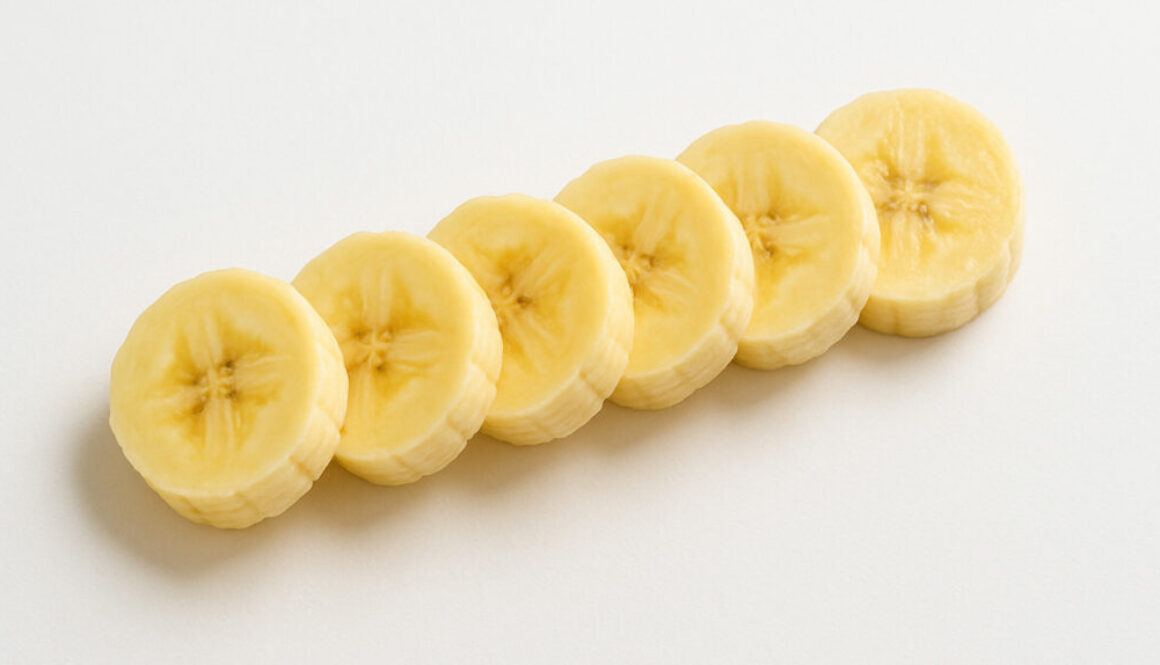 Diagonal top view of sliced banana on clean white background in 16:9 format