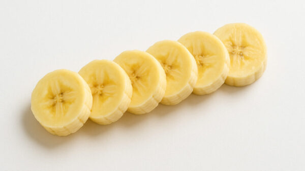 Diagonal top view of sliced banana on clean white background in 16:9 format