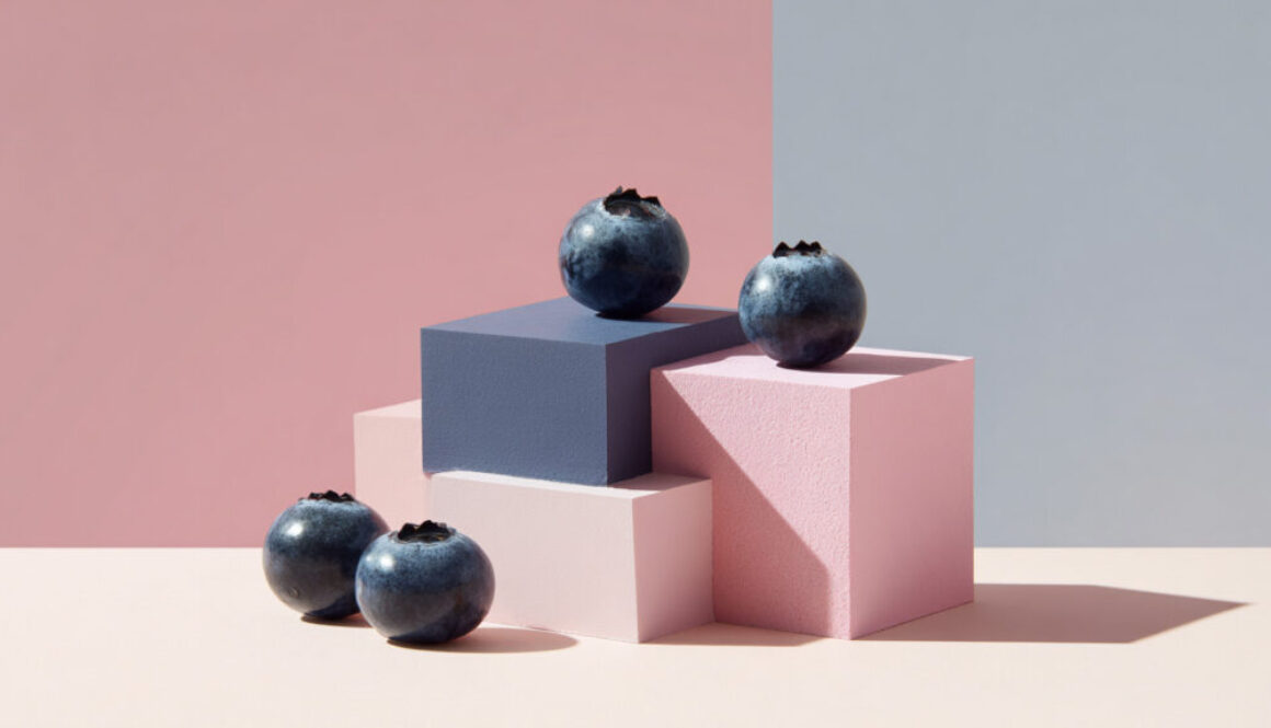 Contemporary still life of blueberries on pink and blue geometric blocks in 16:9 format