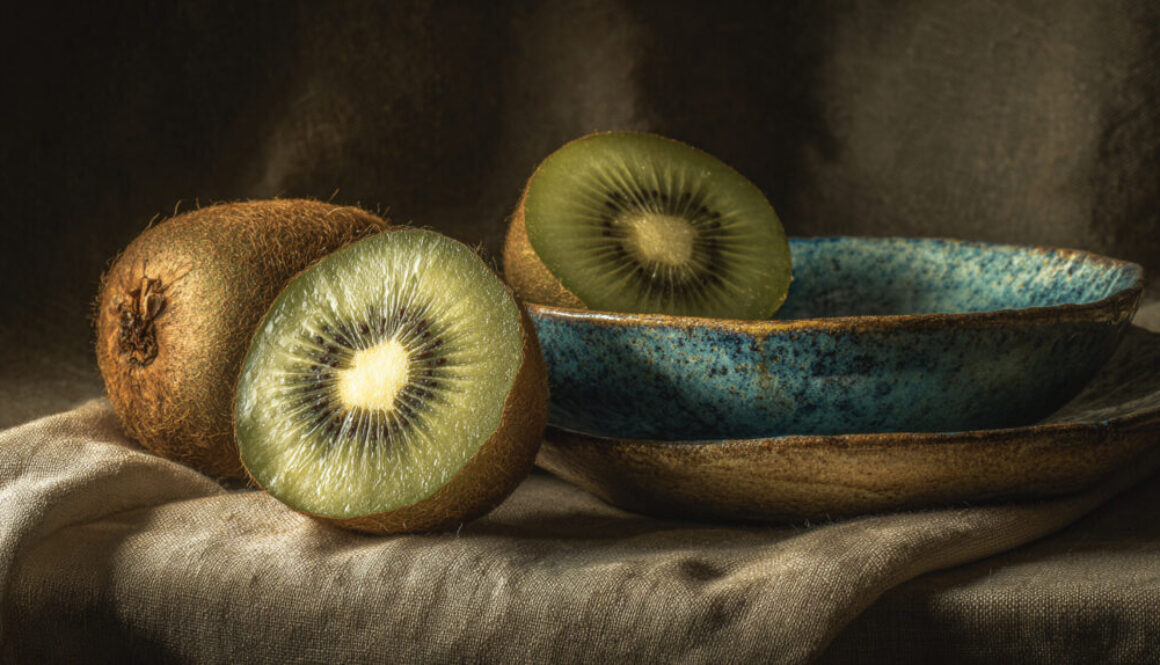 Rustic still life with fresh kiwi and ceramic bowl on linen background