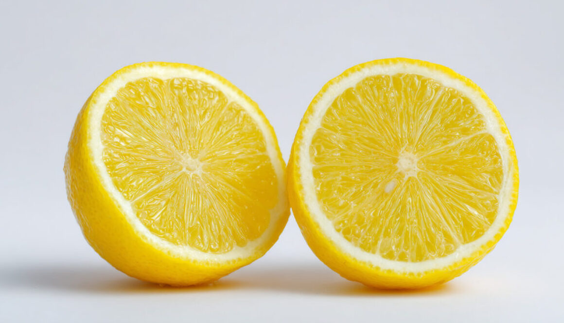 Two juicy lemon halves on clean white background in 16:9 format